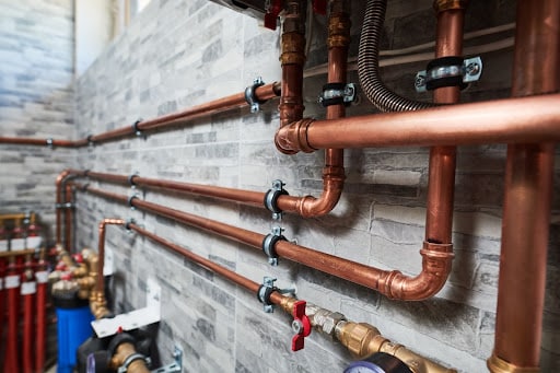 Copper pipeline of a heating system in boiler room https://constructmeasures.com/all-trades/